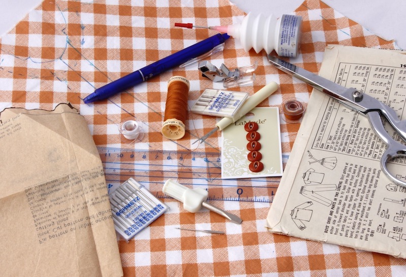 Messy workspace with sewing needles and fabric